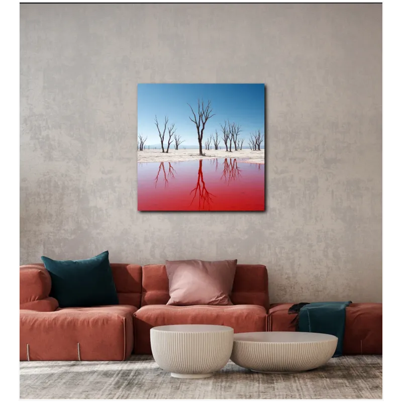 Bare Desert Trees With Vibrant Red Lake Reflection